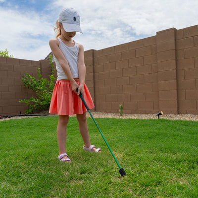 Young junior golfer swinging the light SuperSpeed training stick fast